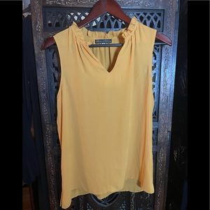 Sleeveless blouse with ruffle neck
